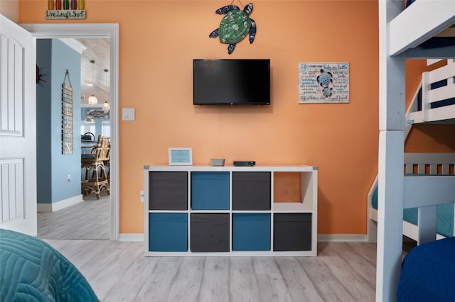 bedroom featuring baseboards and wood finished floors