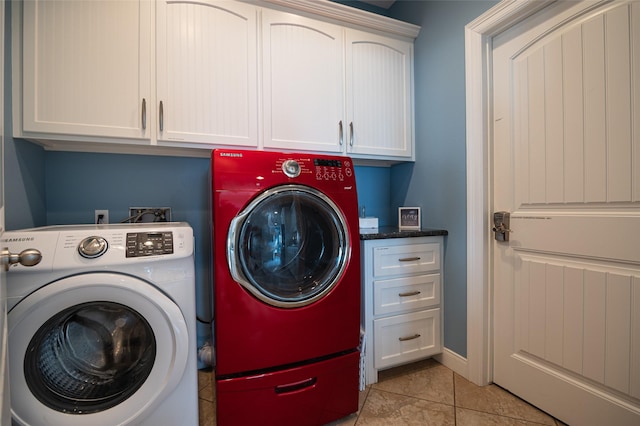 washroom featuring light tile patterned floors, cabinet space, and washer and clothes dryer