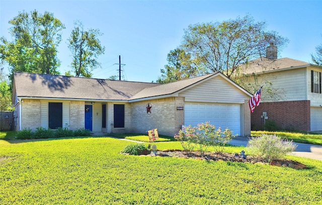 single story home featuring brick siding, an attached garage, and a front yard