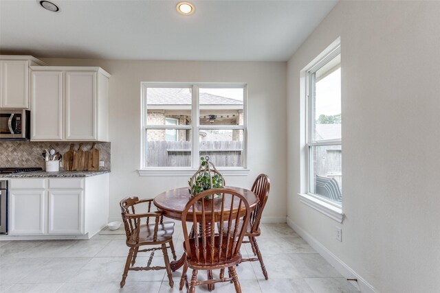 dining space featuring recessed lighting and baseboards