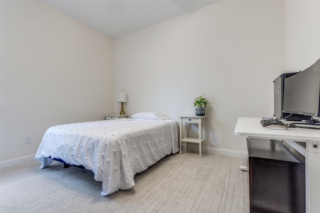 bedroom with light carpet and baseboards