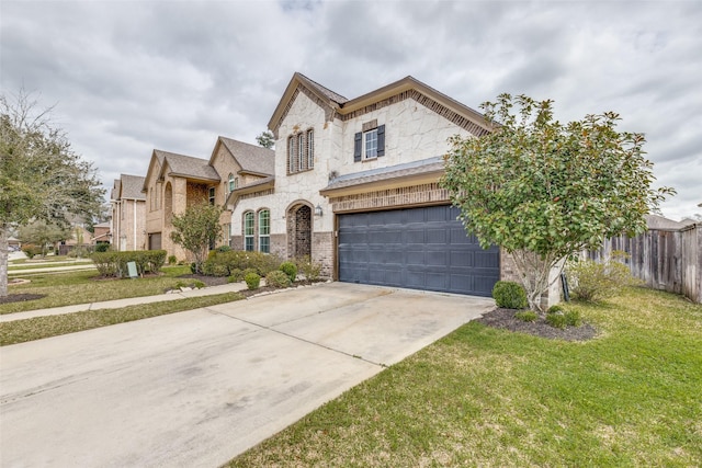 french country style house featuring fence, driveway, an attached garage, a front lawn, and brick siding