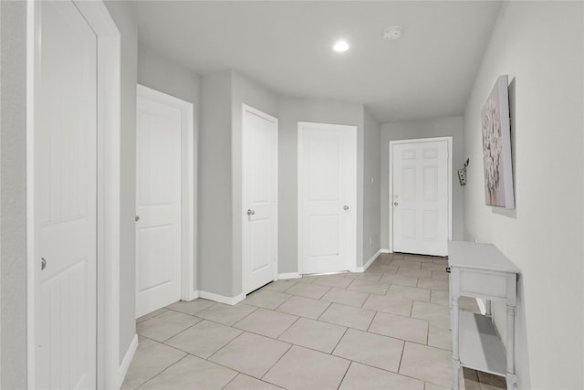 interior space featuring light tile patterned floors and baseboards