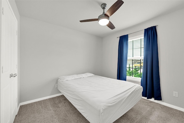 carpeted bedroom with a ceiling fan and baseboards