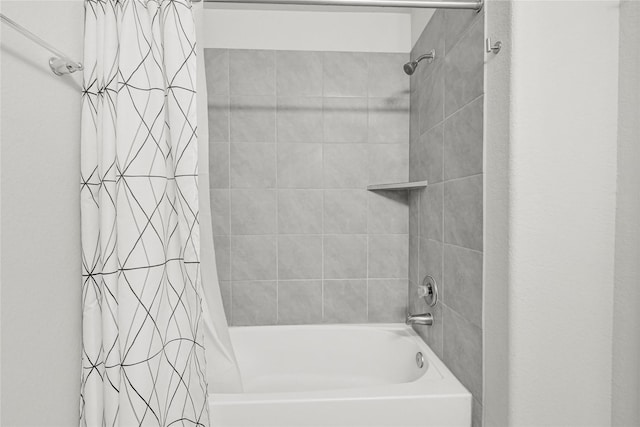 bathroom with shower / bath combo with shower curtain