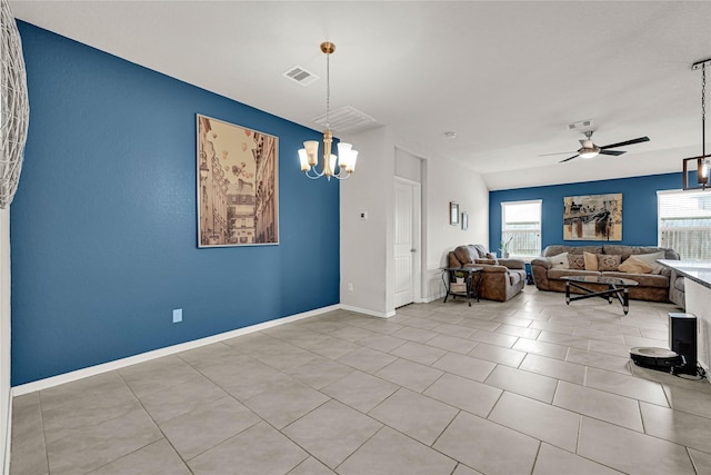 unfurnished living room featuring visible vents, baseboards, tile patterned flooring, and ceiling fan with notable chandelier