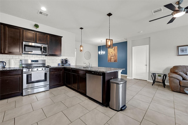 kitchen featuring a sink, visible vents, appliances with stainless steel finishes, and open floor plan