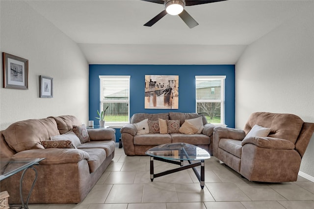 living area featuring light tile patterned flooring, a ceiling fan, and vaulted ceiling