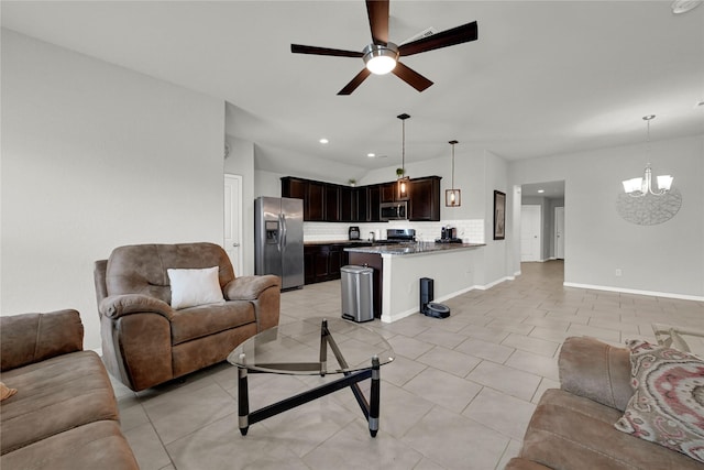 living area featuring light tile patterned floors, baseboards, recessed lighting, and ceiling fan with notable chandelier