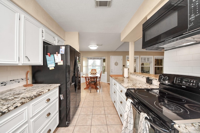 kitchen with visible vents, black appliances, tasteful backsplash, white cabinetry, and light tile patterned floors