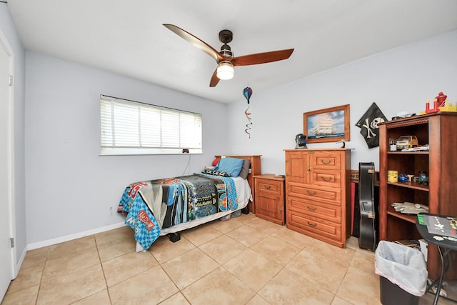 bedroom with light tile patterned flooring, a ceiling fan, and baseboards