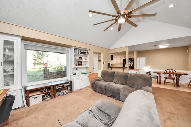 living area featuring light carpet, high vaulted ceiling, a textured ceiling, and ceiling fan