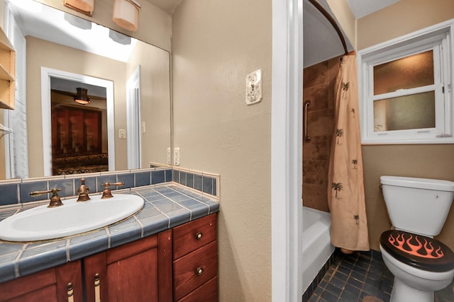 full bath featuring tile patterned floors, toilet, vanity, and shower / bath combination with curtain