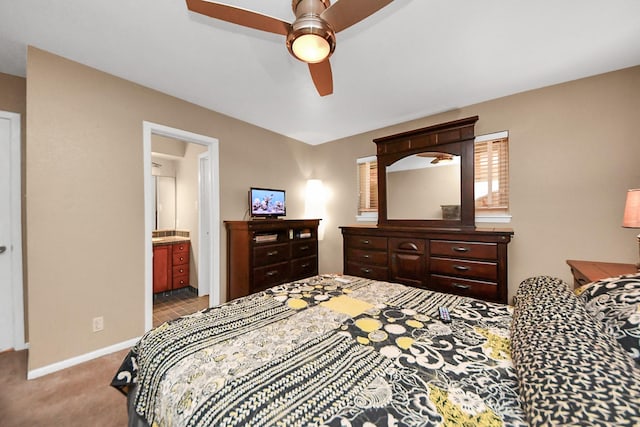 carpeted bedroom with baseboards, ensuite bathroom, and ceiling fan