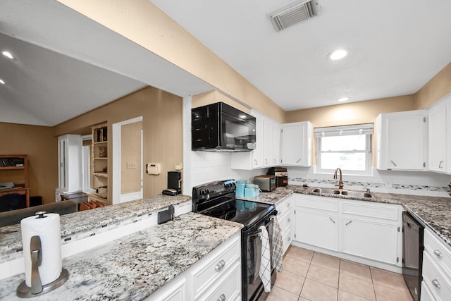 kitchen featuring white cabinetry, black appliances, visible vents, and a sink