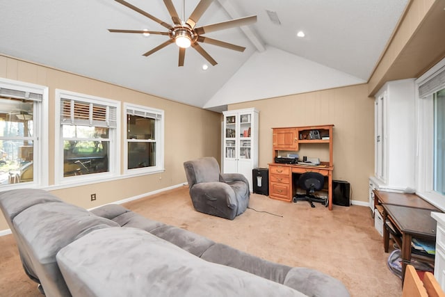 living area featuring baseboards, visible vents, lofted ceiling with beams, ceiling fan, and light colored carpet