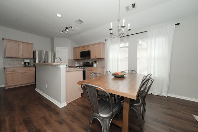 dining space featuring dark wood finished floors, vaulted ceiling, a notable chandelier, and visible vents