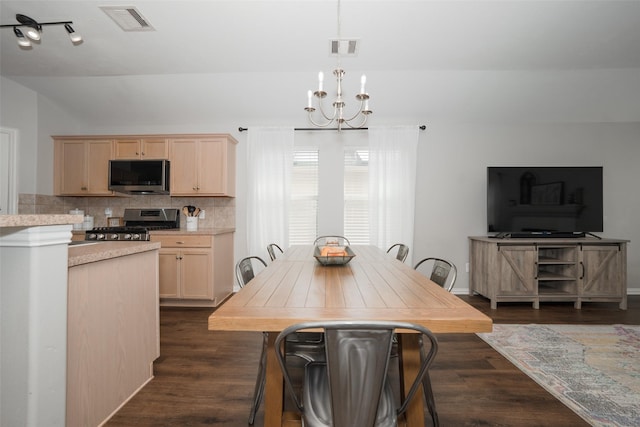 dining space with visible vents, baseboards, a notable chandelier, and dark wood-style floors