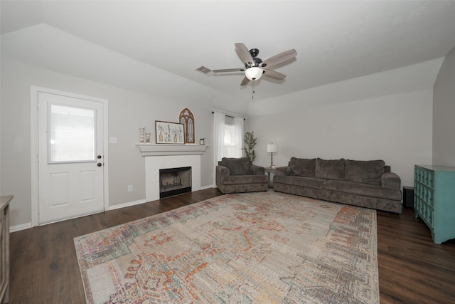 living area with visible vents, baseboards, a tile fireplace, a ceiling fan, and dark wood-style flooring