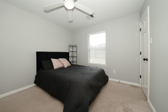 bedroom featuring light carpet, visible vents, and baseboards