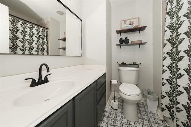 bathroom featuring vanity, toilet, baseboards, and visible vents