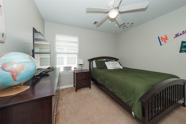 bedroom featuring a ceiling fan, light colored carpet, and visible vents