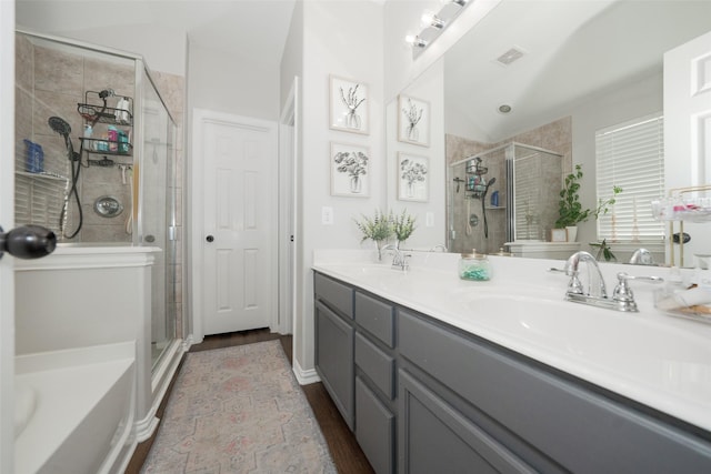 full bath with a shower stall, double vanity, visible vents, and a sink