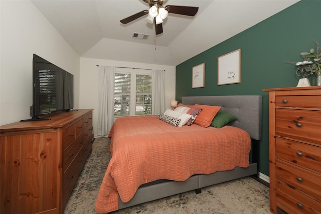 bedroom featuring visible vents, a raised ceiling, lofted ceiling, and a ceiling fan