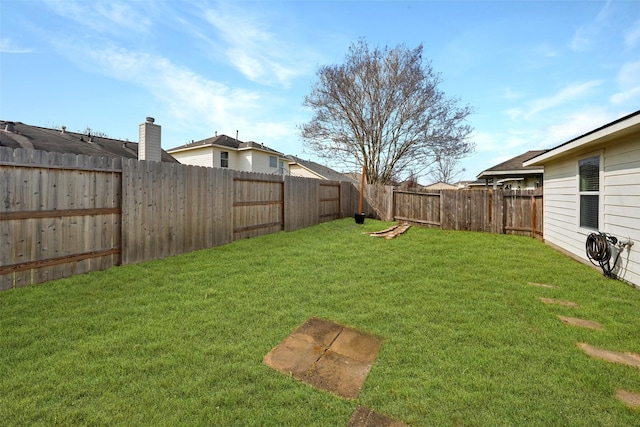 view of yard with a fenced backyard