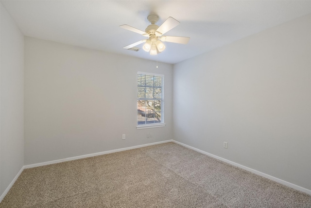 spare room with baseboards, carpet, and a ceiling fan