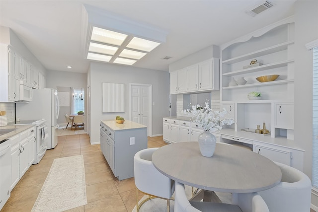 kitchen with visible vents, light countertops, white appliances, white cabinetry, and open shelves