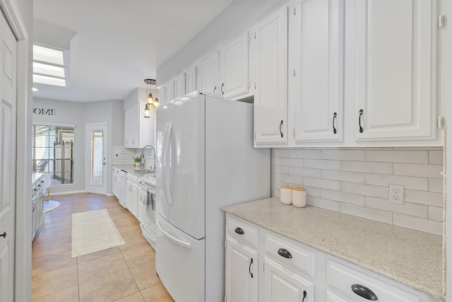 kitchen with backsplash, white cabinets, white appliances, and light tile patterned flooring