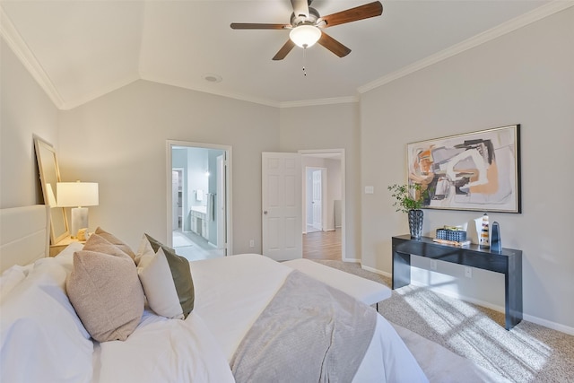 bedroom with crown molding, baseboards, ensuite bathroom, and vaulted ceiling