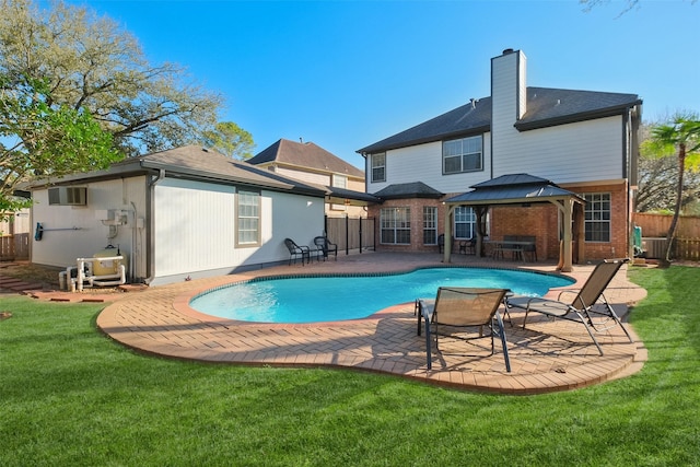 view of pool with a lawn, a patio, fence, a gazebo, and a fenced in pool