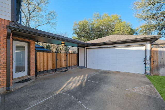 detached garage featuring fence