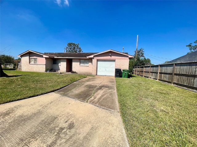 single story home with a garage, a front yard, driveway, and fence