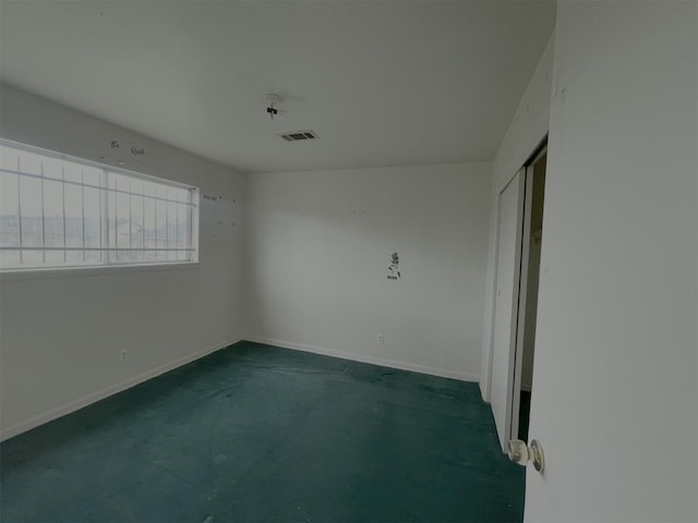 empty room with baseboards and visible vents