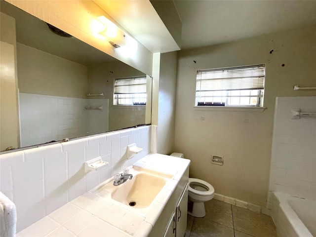 bathroom featuring tile patterned flooring, toilet, vanity, and baseboards