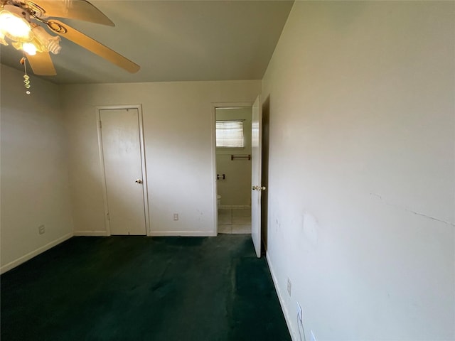 unfurnished bedroom featuring a ceiling fan, baseboards, and carpet floors