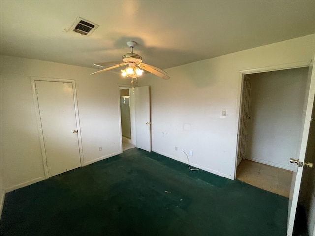 unfurnished bedroom featuring a ceiling fan, visible vents, and baseboards