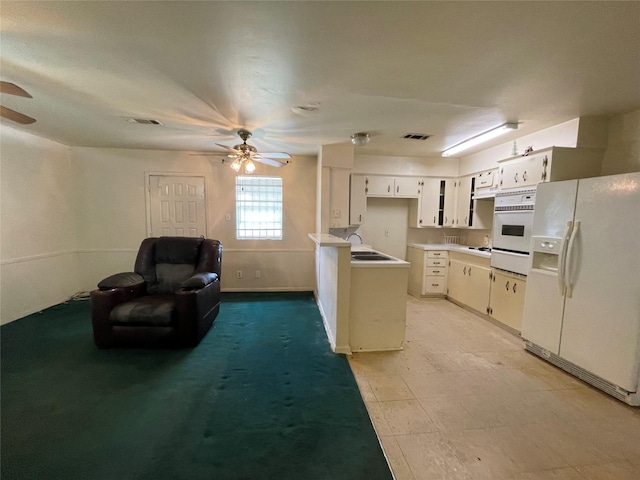 kitchen featuring visible vents, white appliances, and a ceiling fan