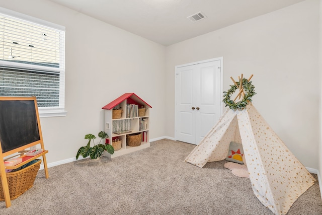 rec room with visible vents, baseboards, and carpet