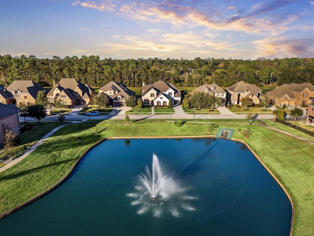 bird's eye view featuring a water view and a residential view