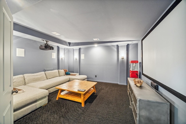 home theater room featuring dark carpet and baseboards