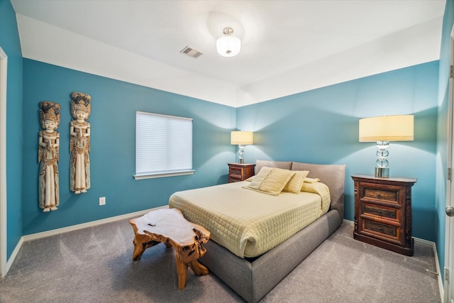 carpeted bedroom featuring visible vents and baseboards