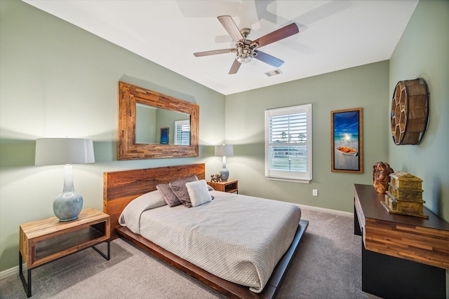 bedroom with visible vents, carpet floors, baseboards, and ceiling fan