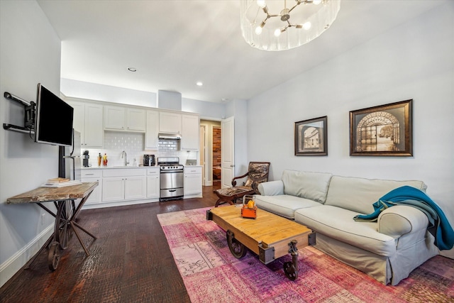 living area with recessed lighting, baseboards, a notable chandelier, and dark wood-style floors