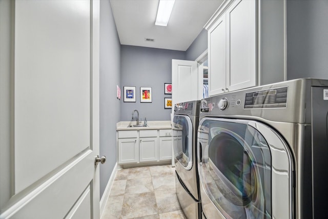 laundry area featuring visible vents, baseboards, cabinet space, independent washer and dryer, and a sink