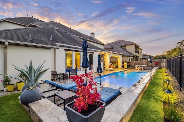 view of pool with a fenced in pool, a fenced backyard, and a patio area