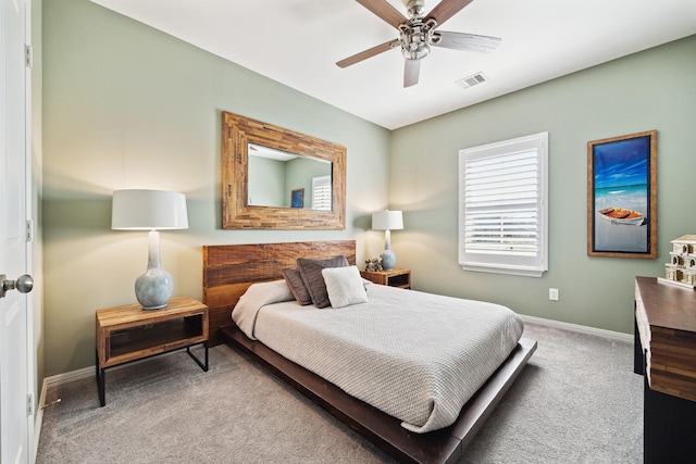 bedroom featuring visible vents, baseboards, ceiling fan, and carpet flooring